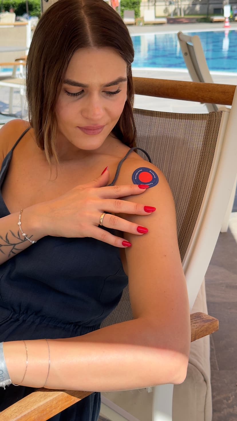 Woman applying Purisaki Berberine Patch to her shoulder